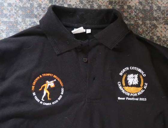 A black polo shirt with embroidered logos

Description automatically generated with low confidence