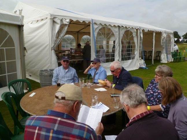 A group of people sitting around a table

Description automatically generated with medium confidence