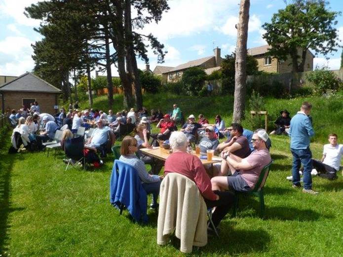 A group of people sitting in chairs outside

Description automatically generated with low confidence