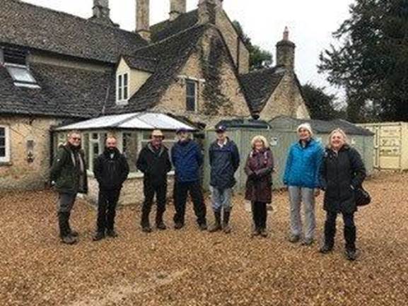 A group of people standing outside a house

Description automatically generated with medium confidence