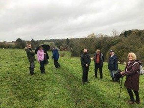 A group of people standing in a field

Description automatically generated with medium confidence