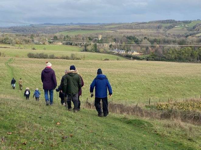 A group of people walking in a field

Description automatically generated with medium confidence